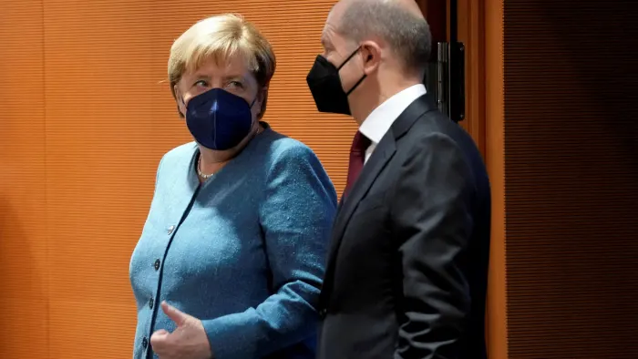 Germany's former chancellor Angela Merkel next to new chancellor Olaf Scholz