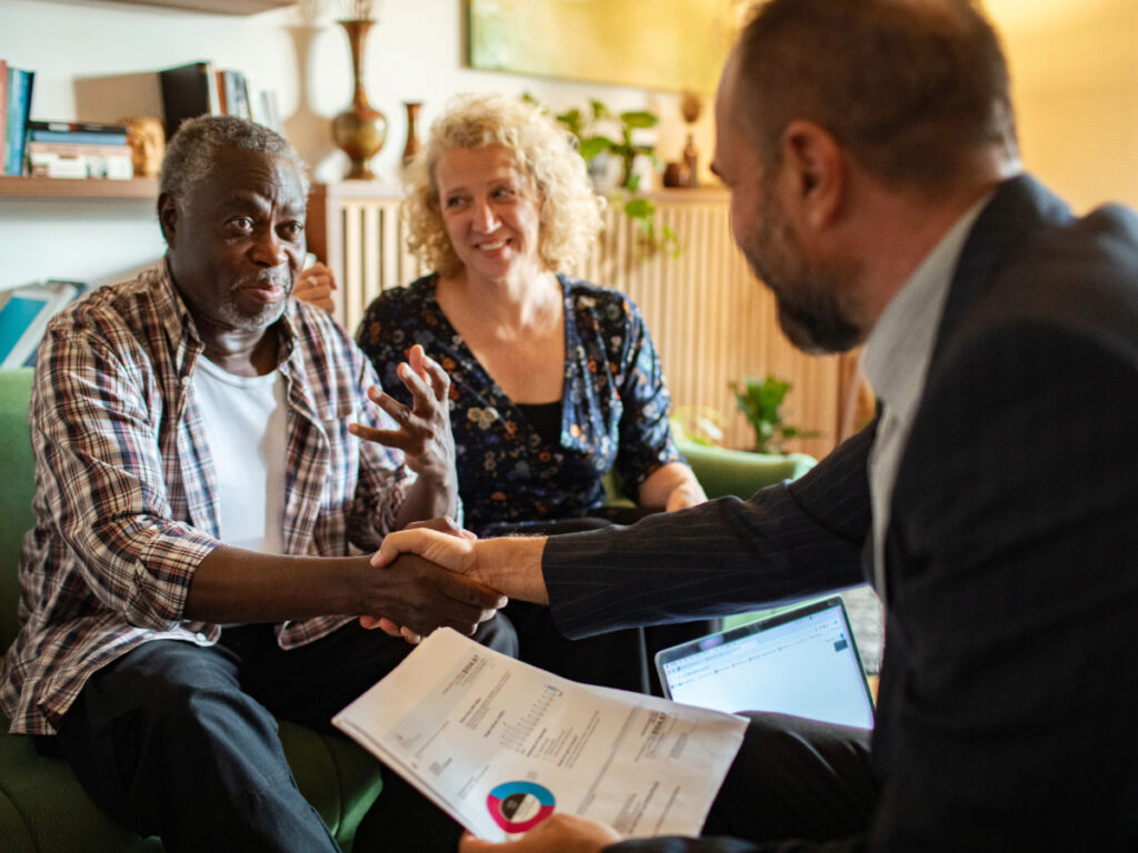 Middle-aged couple discussing finance with advisor